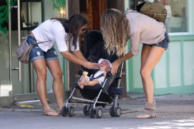 Gisele Bundchen, jean shorts, denim shorts, pink blouse, sunglasses, sandals, bracelets, beige top, stroller, benjamin brady